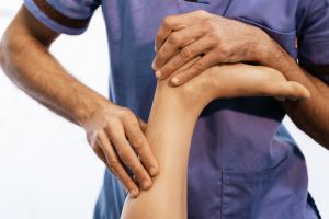 Physiotherapist Giving Knee Therapy To A Woman